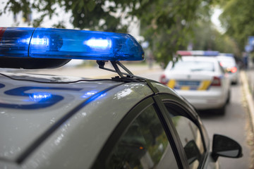 the patrol car with flashing lights on © Oleksandr