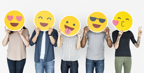 Diverse people holding happy emoticons - Powered by Adobe