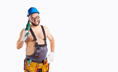 The fat funny man builder with a drill on a background for text.
