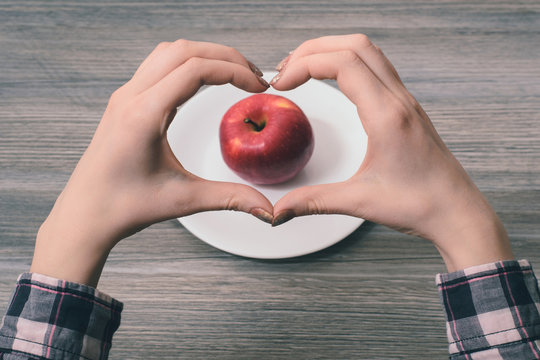 I Choose Healthy Food!Close-up Photo Of Woman's Hands Making Heart Frame With Her Fingers With Apple In The Center On The Frame. I Choose Healthy Food!