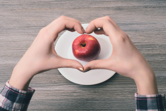 I Choose Healthy Food!Close-up Photo Of Woman's Hands Making Heart Frame With Her Fingers With Apple In The Center On The Frame. I Choose Healthy Food!