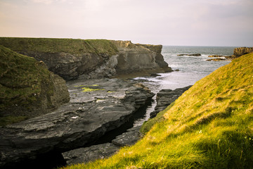 Fototapeta na wymiar Landscape with cliffs at Bridge of Ross near Kilkee, Ireland