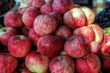 organic fruit apples on the farm market. Ripe juicy apples as background