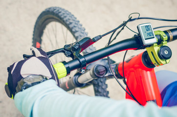 Cyclist on an orange bike riding a bicycle path
