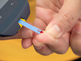 Close up shot of woman's hands making blood sugar level test