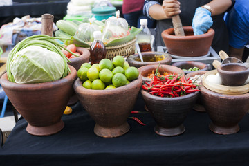 Clay bowls with fresh vegetables cabbage, lime and chili peppers