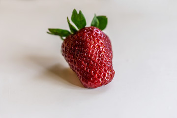 Close-up of hand with juicy ripe strawberries. Vintage background, shallow depth of focus. Concept...