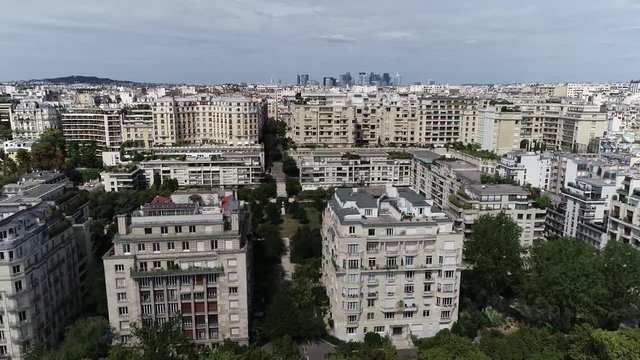 Aerial footage moving left past Paris apartments located in the16th arrondissement also showing La Defense in background the major business district three kilometres west of the city limits 4k