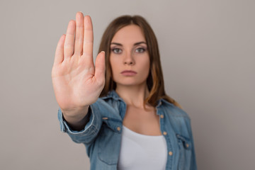 Close up cropped photo of hand making showing demonstrating a sign stop with a hand, serious...