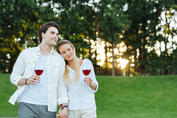 Fototapeta premium We are together. Happy positive couple holding their hands while being outdoors together