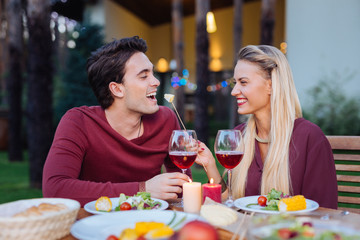So delicious. Joyful cheerful woman smiling while giving cheese to her husband