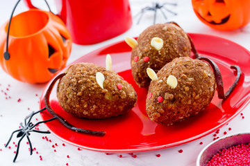 Chocolate mice cakes for Halloween , edible rat cakes on red plate , terrifying treats for Halloween party