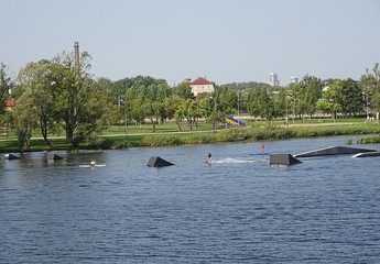 Recreation Leisure Park On The River Bank Coast. Wakeboard Surfing Wakeboarding  Zone With Springboards In The City Center. Popular Place for Water Sports.  