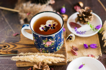 Flower tea: pansies, edible flowers, on a light background