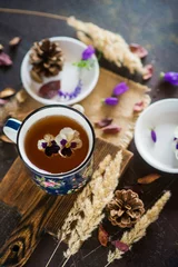 Fototapeten Stiefmütterchen Flower tea: pansies, edible flowers, on a light background  © malykalexa777