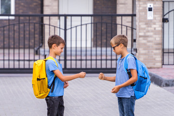 Two boys playing rock paper scissors game after school