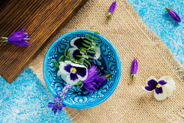 Flower tea: pansies, edible flowers, on a light background