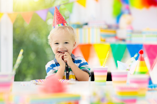 Kids Birthday Party. Child Blowing Out Cake Candle