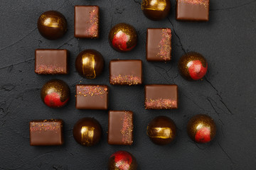 Set of luxury handmade bonbons on black background