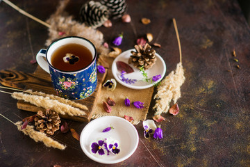 Herbal tea: pansies, petals, edible flowers, on a light background