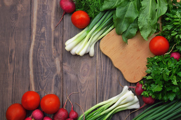 Flat-lay of tomatoes, radishes, parsley, spinach, dill, cilantro, sorrel, top view. seasonal produce for healthy cooking.