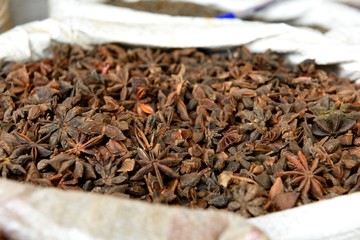 Basket of fresh raw Star Anise, or Illicium verum in a spice market in Jaipur, Rajasthan, India. 