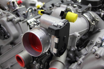 Model of new car V12 engine - throttle pipe with throttle position sensor and mass air flow sensor on motor block