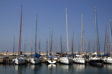 Fototapeta na wymiar Yachts and boats in the port by the sea