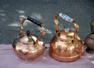 Two antique copper teapots on the flea market