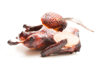 Roasted  duck with slice on fork isolated on white