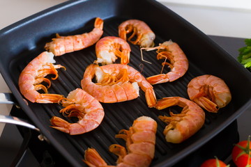Food. Langoustines, induction stove, grill pan