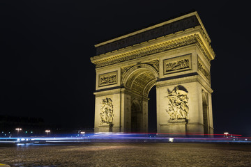 Fototapeta na wymiar Street view of Arc de Triomphe (Triumphal Arch) in Chaps Elysees at night, Paris, France.