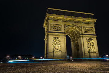 Fototapeta na wymiar Street view of Arc de Triomphe (Triumphal Arch) in Chaps Elysees at night, Paris, France.