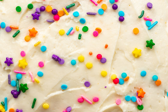 Close up of vanilla buttercream icing with colorful confetti sprinkles