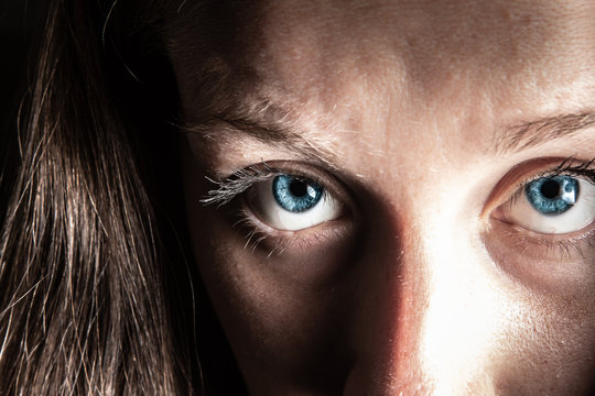 Deep blue eye of woman in dark style image