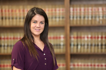 Young attractive woman attorney in law library