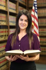 Young attractive woman attorney in law library