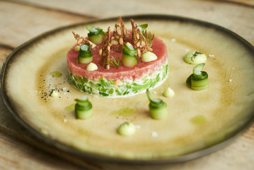 Luxury vegetarian food with wild shrimps, young cabbage, tomato fillet and citronette sauce, close-up