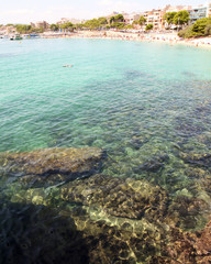 View of clear blue water over rocks and reefs in the Mediterranean. At Porto Cristo beach, Mallorca