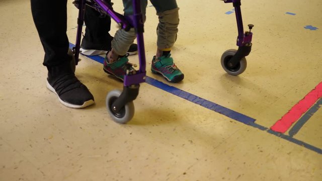 Young Girl With Cerebral Palsy Is In Physical Therapy And Working On Her Steps