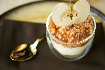 Dessert New york cheese cake with mousse with apple cream, caramel, muskovado, close-up. Healthy breakfast food