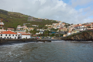 Fototapeta na wymiar Black stone beach in Câmara de Lobos, Madeira