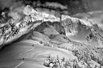 Aerial view of skiers skiing down a mountain