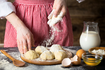 Making dough by female hands at bakery