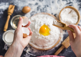 Making dough by female hands at bakery