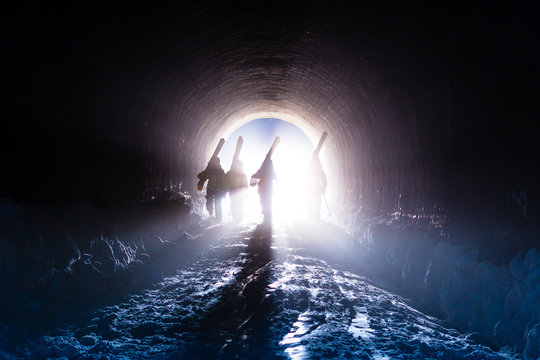 Four skiers in a tunnel a ski resort