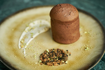 Fondant dessert and pistachio ice cream with English cream, pistachio crumble and sauce bailies