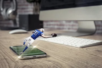 Foto op Plexiglas Football Player with a blue uniform playing and coming out of a full screen phone on a wooden table. © beto_chagas