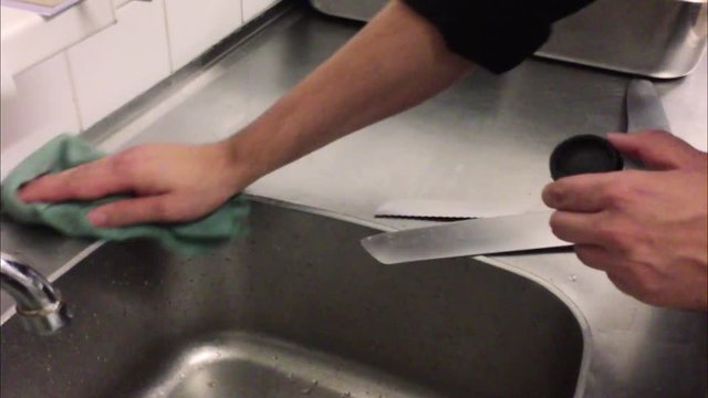 Cleaning the kitchen of a restaurant with a cloth