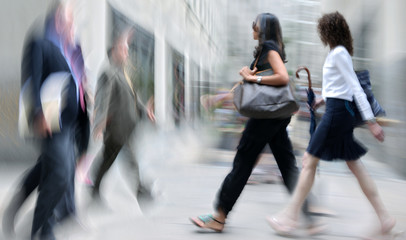 motion blurred business people walking on the street